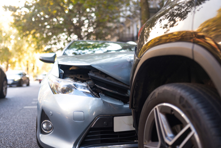 Close-up of two cars damaged in road traffic accident