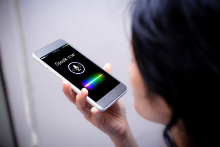 Close-up of woman talking on her mobile phone to Siri/ChatGBPT