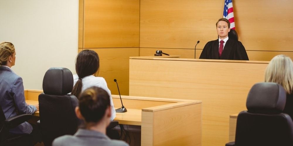 Judge with American flag behind him