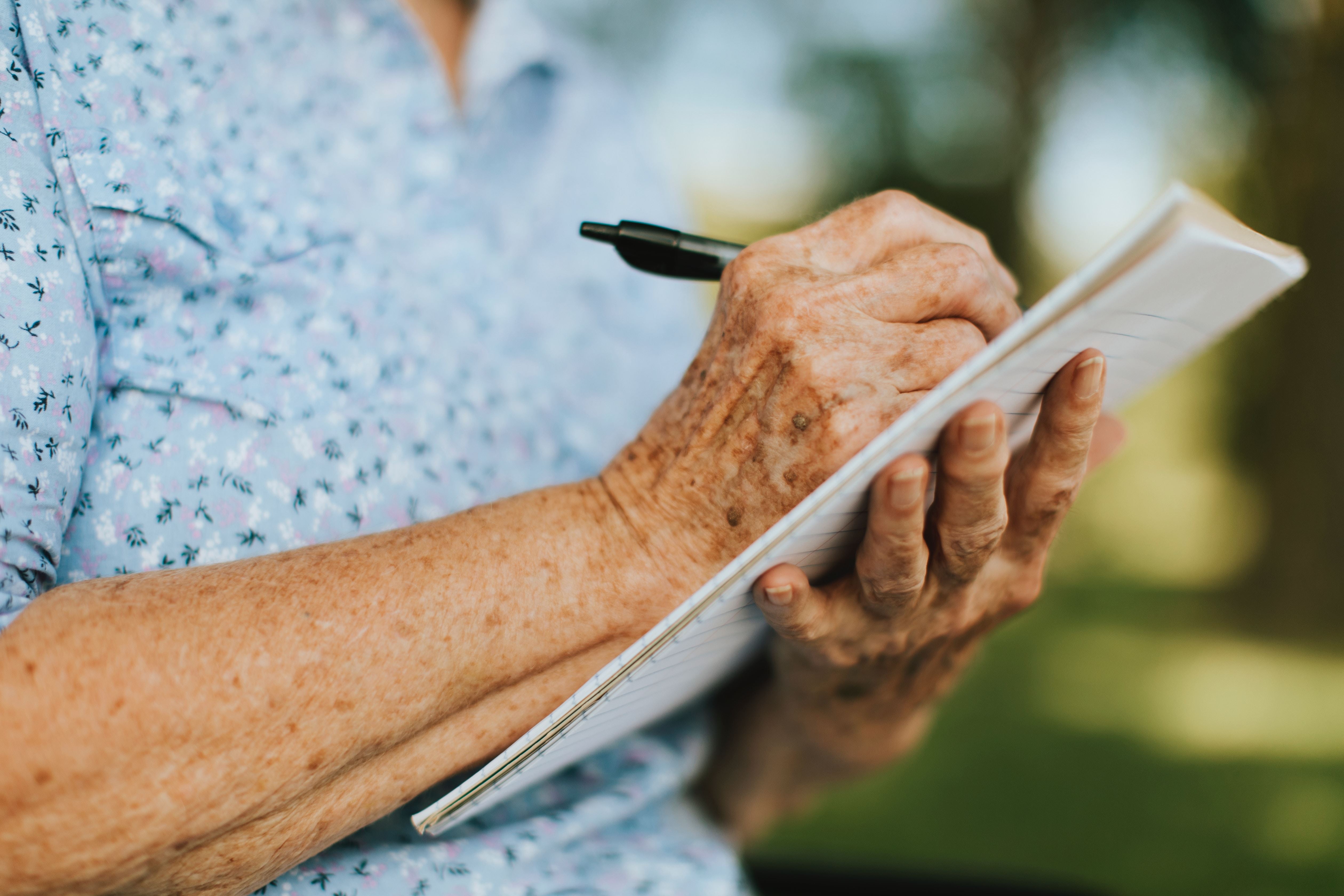 Man holding pen and paper