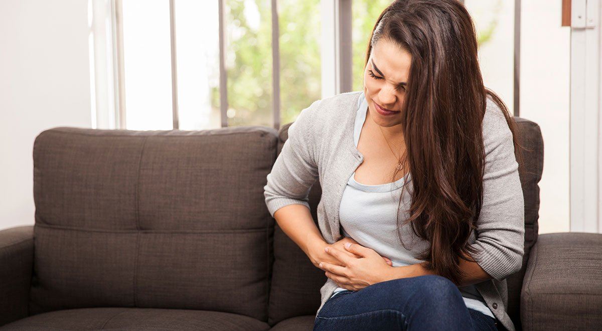 Woman holding her stomach in pain