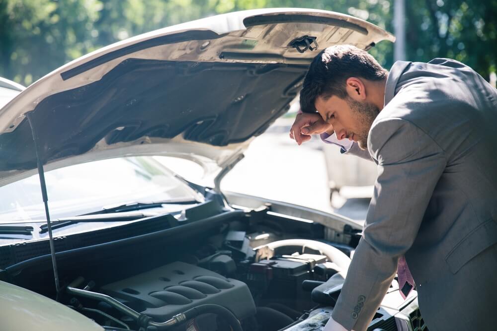 Man checking car hood