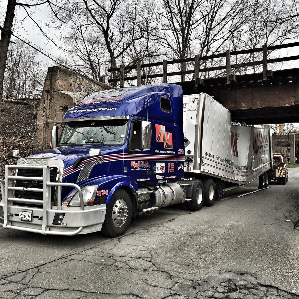 truck bridge collision Truck wedged under a low bridge. 