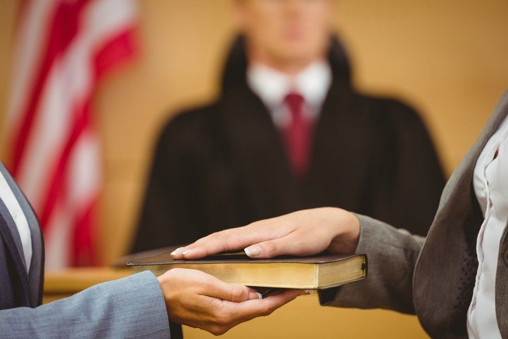 Witness hand on the bible