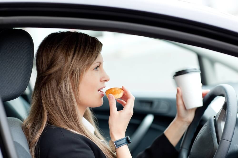 Woman eating while driving