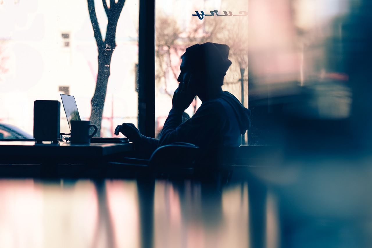 woman on the phone and using laptop